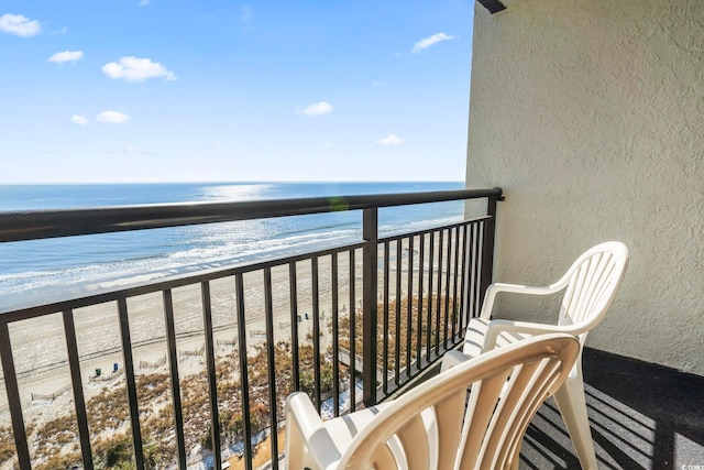 balcony with a view of the beach and a water view