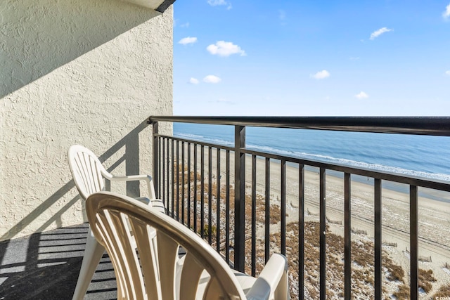 balcony with a beach view and a water view