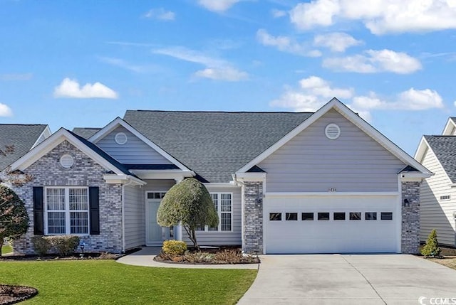 view of front of house featuring a garage, brick siding, concrete driveway, roof with shingles, and a front yard