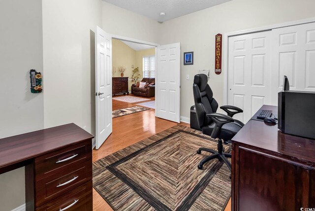 office with light hardwood / wood-style floors