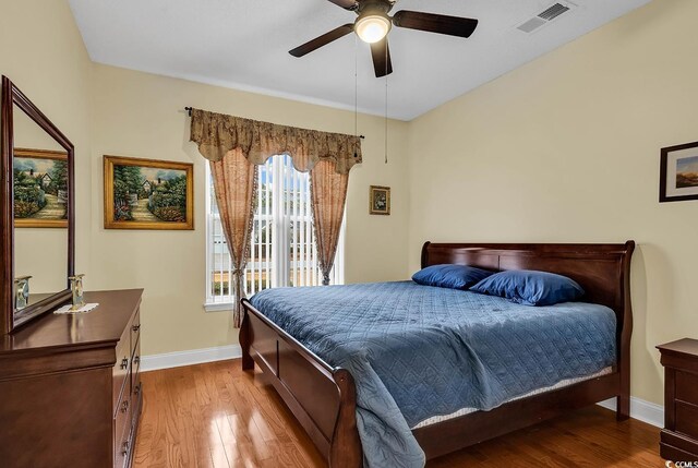 bedroom with ceiling fan and light wood-type flooring