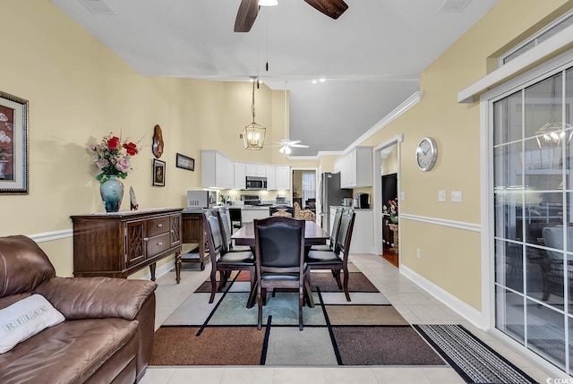 tiled dining space with crown molding and ceiling fan