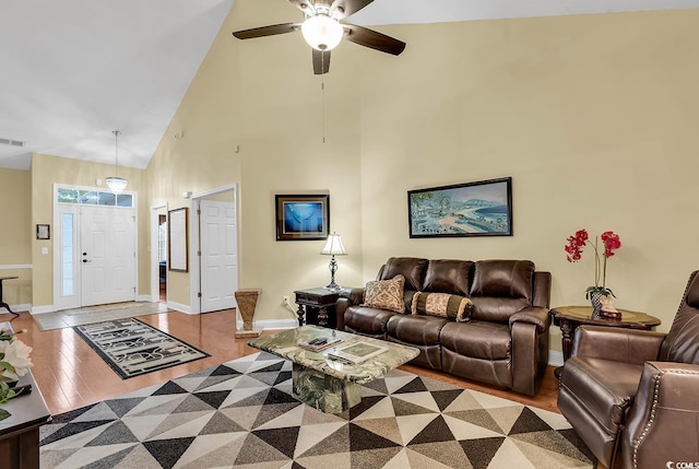 living room featuring high vaulted ceiling, light hardwood / wood-style floors, and ceiling fan