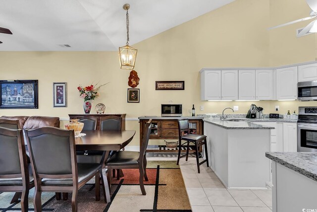 kitchen featuring sink, white cabinets, light stone counters, kitchen peninsula, and stainless steel appliances