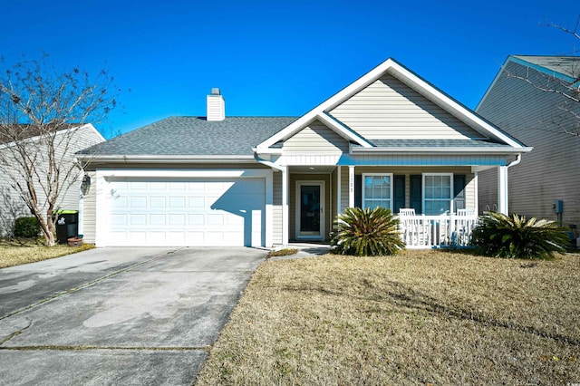 view of front of home with a garage, a front yard, and covered porch