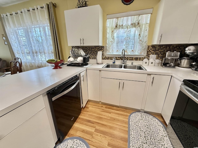 kitchen featuring sink, white cabinetry, tasteful backsplash, light wood-type flooring, and dishwasher