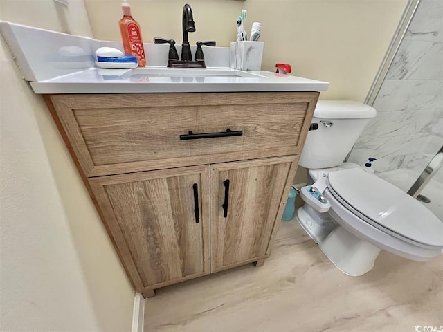 bathroom with vanity, walk in shower, and toilet