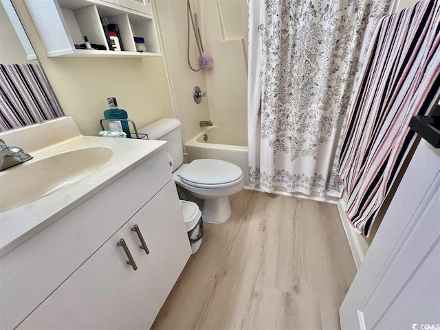 full bathroom featuring vanity, hardwood / wood-style floors, shower / bath combination with curtain, and toilet