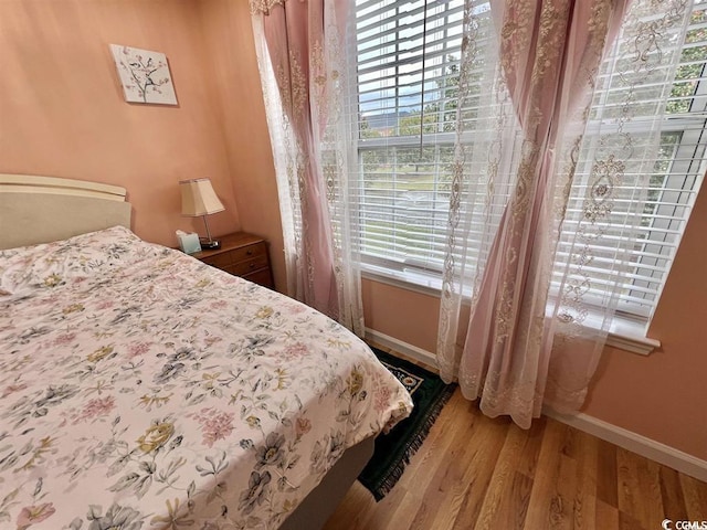 bedroom with hardwood / wood-style flooring