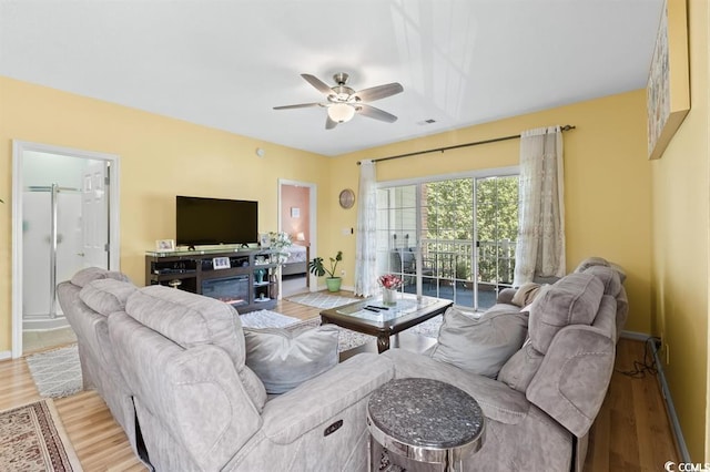 living room with ceiling fan and light hardwood / wood-style floors