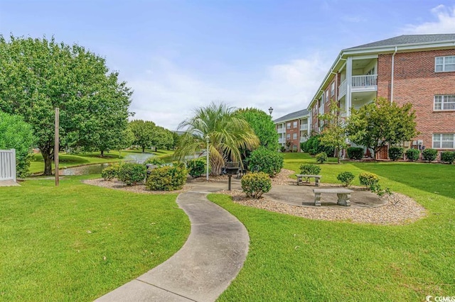 view of property's community with a lawn