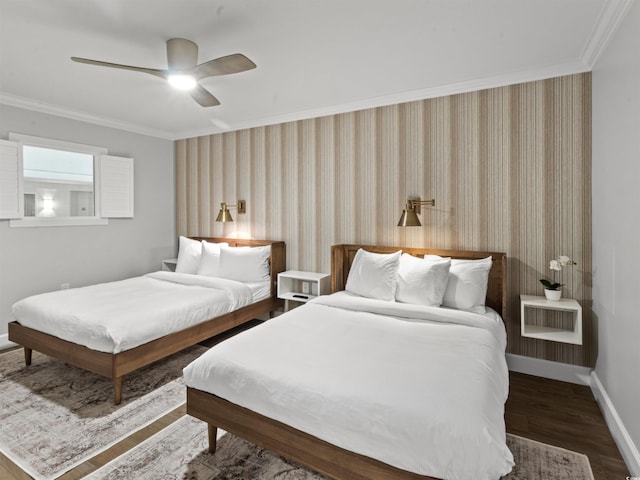 bedroom with wallpapered walls, crown molding, baseboards, wood finished floors, and a ceiling fan