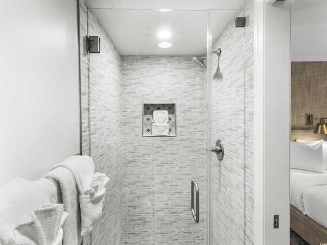 ensuite bathroom featuring a shower stall and ensuite bathroom