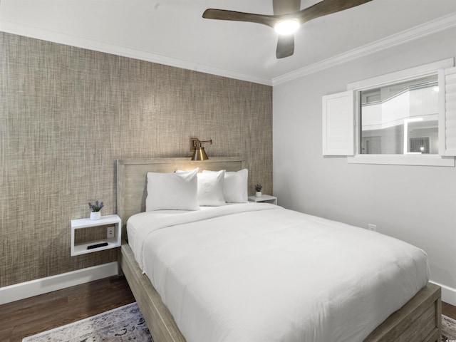 bedroom with ceiling fan, baseboards, wood finished floors, and crown molding