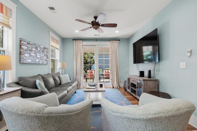 living room featuring ceiling fan and light hardwood / wood-style floors