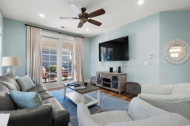 living room with wood-type flooring and ceiling fan