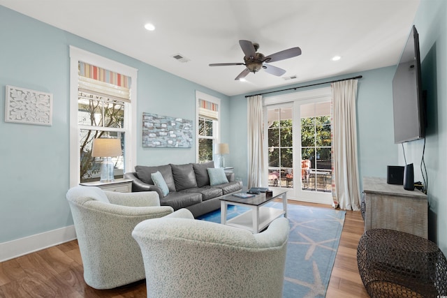 living room featuring light hardwood / wood-style floors and ceiling fan