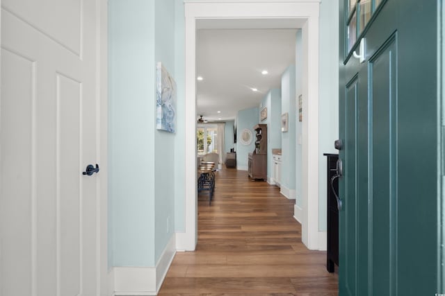 corridor with hardwood / wood-style flooring