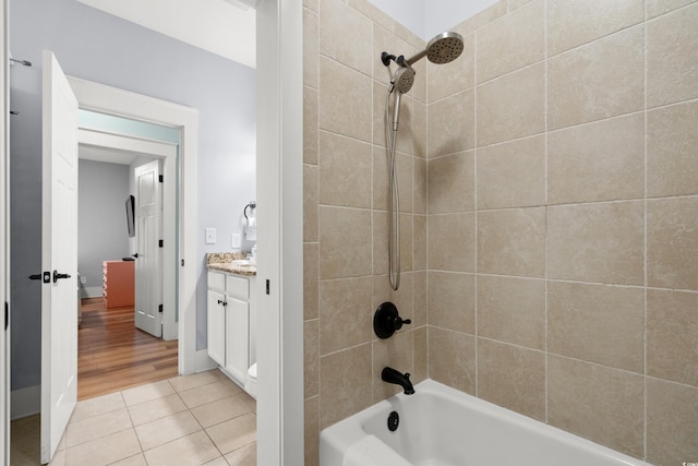 bathroom featuring vanity, tiled shower / bath combo, and tile patterned floors