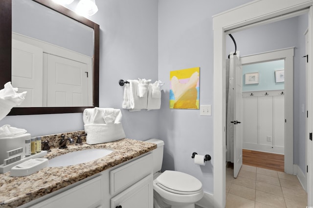 bathroom with vanity, tile patterned floors, and toilet