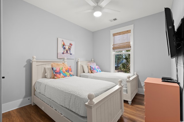 bedroom with dark hardwood / wood-style floors and ceiling fan