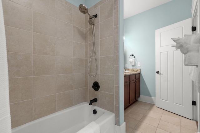 bathroom with tile patterned flooring, vanity, and tiled shower / bath combo