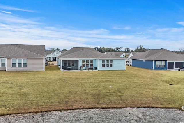1410 Saw Palmetto St, North Myrtle Beach, SC 29582 - back of property featuring a lawn, a sunroom, a residential view, and a water view