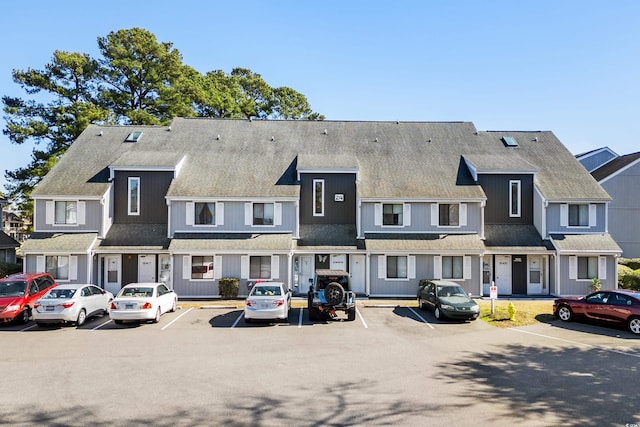 view of property featuring uncovered parking and a residential view