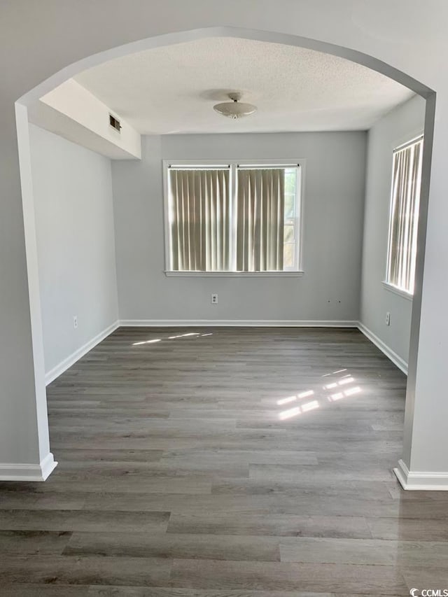 empty room featuring dark hardwood / wood-style flooring