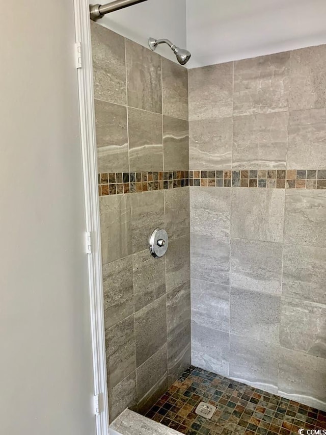 bathroom with a tile shower