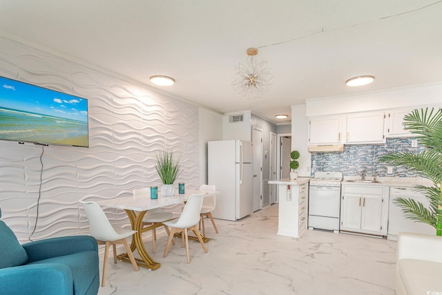 kitchen featuring sink, white cabinetry, decorative light fixtures, white appliances, and backsplash