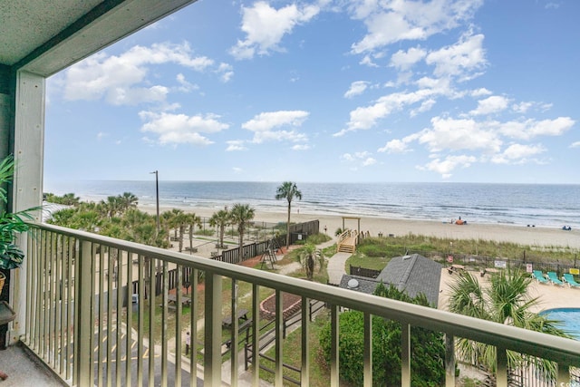 balcony featuring a beach view and a water view