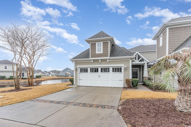 view of front facade featuring a water view and a garage