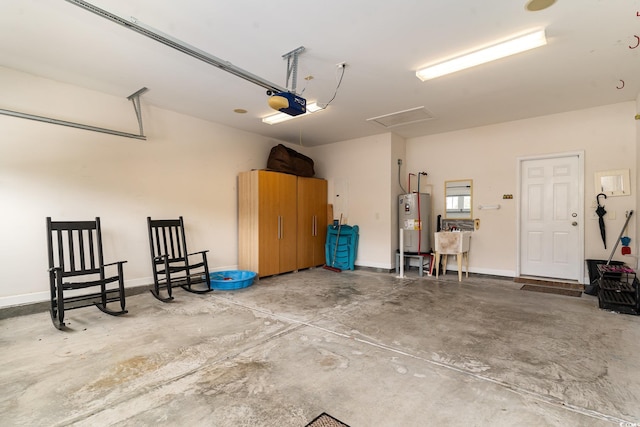 garage with a garage door opener and water heater