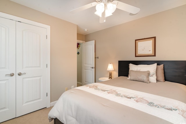 carpeted bedroom with ceiling fan and a closet