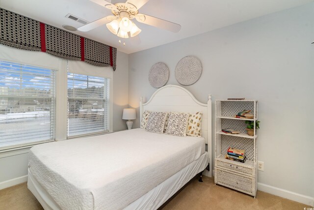 bedroom with ceiling fan and light colored carpet