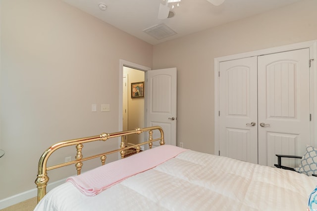 carpeted bedroom featuring a closet and ceiling fan