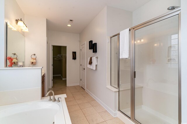 bathroom featuring independent shower and bath, vanity, and tile patterned floors