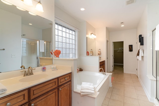 bathroom with shower with separate bathtub, tile patterned floors, and vanity