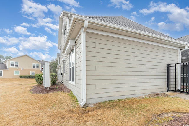 view of property exterior with a yard