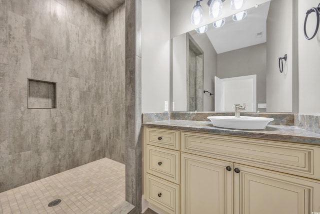 bathroom with vanity and a shower