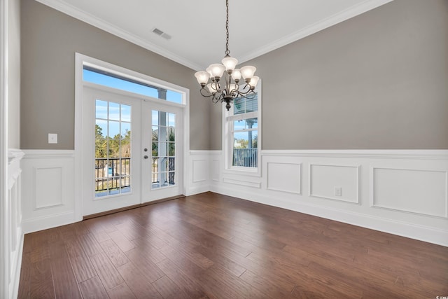 interior space featuring ornamental molding, dark hardwood / wood-style floors, a notable chandelier, and french doors