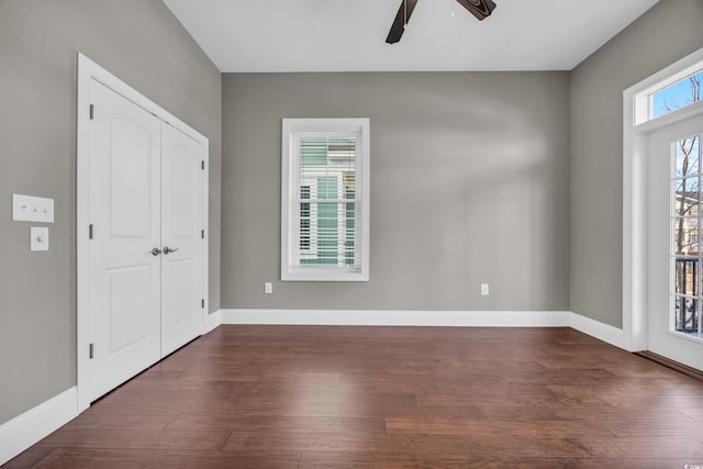 interior space with dark hardwood / wood-style floors and ceiling fan