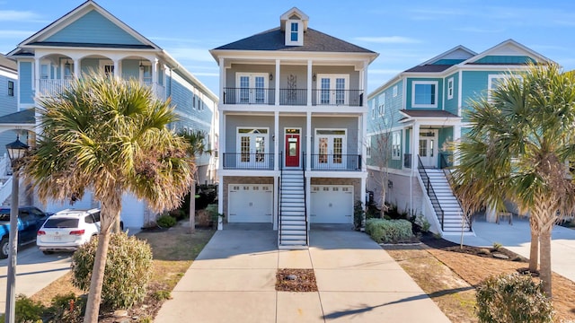 beach home featuring french doors, a balcony, and a garage