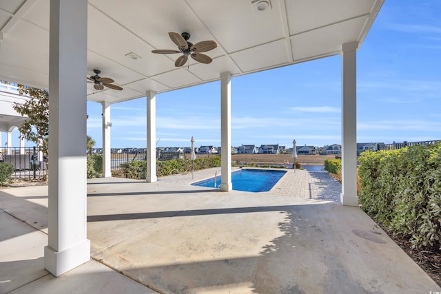 view of swimming pool with ceiling fan and a patio