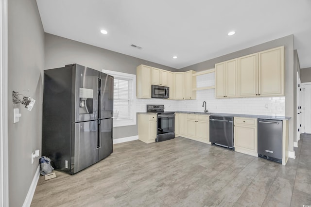 kitchen with sink, backsplash, light hardwood / wood-style floors, and black appliances