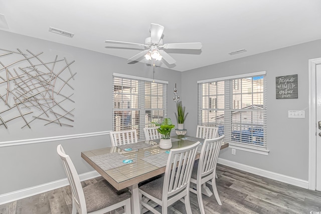 dining area with hardwood / wood-style flooring and ceiling fan