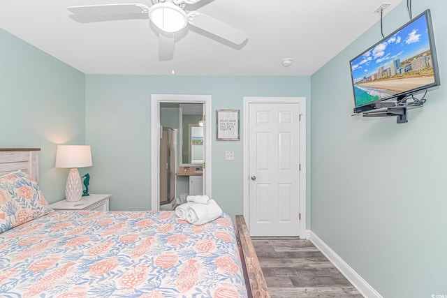 bedroom with hardwood / wood-style flooring, ceiling fan, and ensuite bathroom