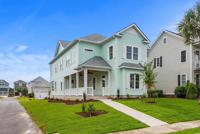 view of front of home featuring a porch, a garage, and a front lawn