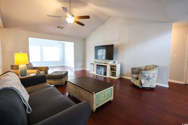 living room featuring dark hardwood / wood-style flooring, vaulted ceiling, and ceiling fan